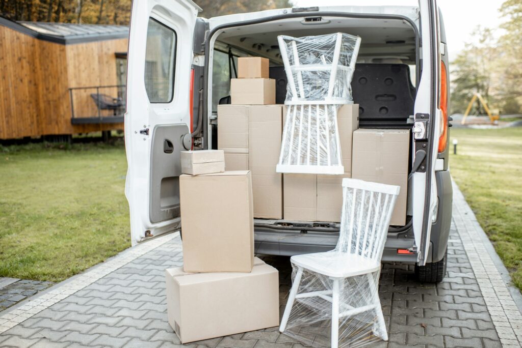 Car trunk full of boxes near a house outdoors